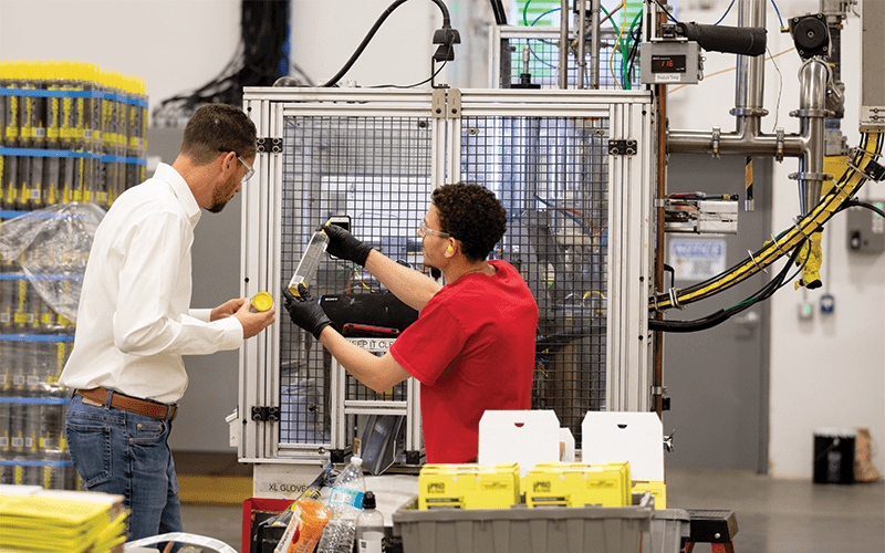 Sashco employee prepping a machine in their factory in Thornton, Colorado.