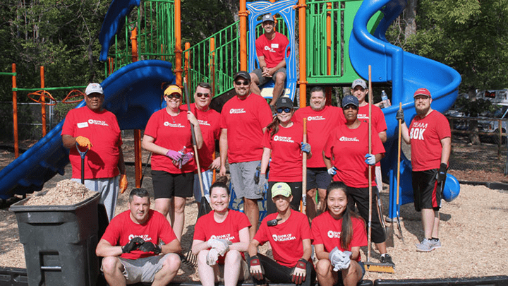 Volunteer workers helping clean up park as part of Bank of Oklahoma’s commitment to community service.