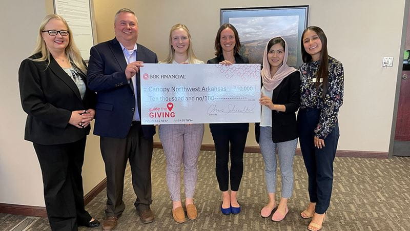 BOK Financial employees present donation to refugee-serving nonprofits in Arkansas and Texas